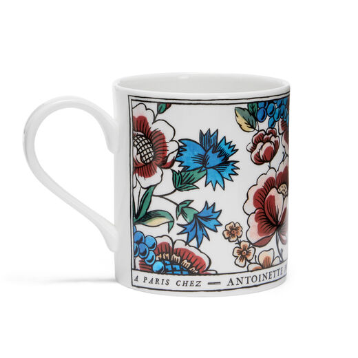 China mug featuring a floral design with blue cornflowers and pink roses.